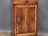 an old wooden cabinet with a drawer on top of it