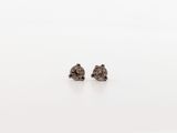 a pair of brown diamond stud earrings on a white surface