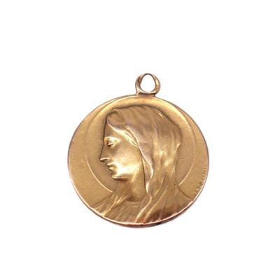 a close up of a gold medal with a woman ' s face on it