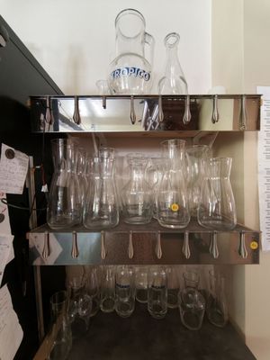 a shelf with wine glasses on it in the kitchen