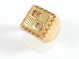 an image of a gold signet ring with the letter f on it