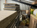 a pile of wood stacked on top of each other in a storage room
