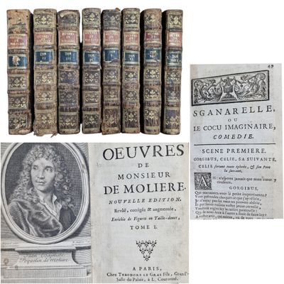 several old books are stacked on top of each other on a white surface