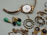 a lot of jewelry that is laying out on the table