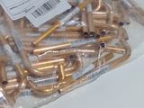 a bag of gold pipes sitting on top of a white table