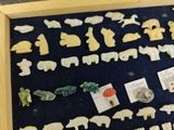 a picture of a display of animal magnets in a wooden frame