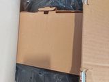 a large white object in the middle of a cardboard box