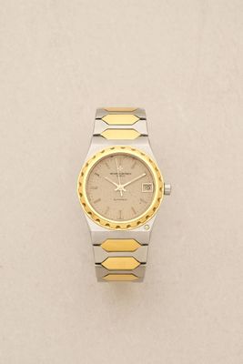 a close up of a watch on a table with a white background