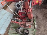 a red tractor that is parked next to a building