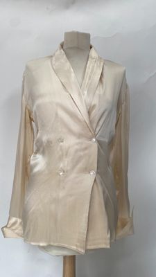 a mannequin with a jacket on it on a wooden stand