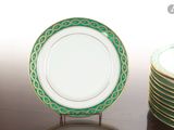 a stack of green and white plates sitting on a table