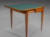 a small table with a green top and wooden legs