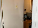 a white door in a room with a computer on a desk