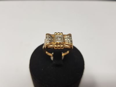 a close up of a gold ring on a black ring stand