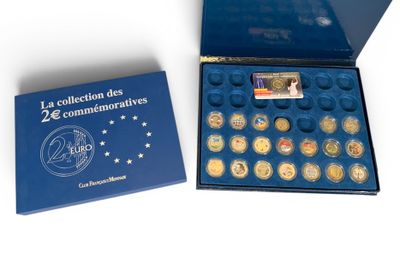 a blue box filled with coins sitting on top of a white surface