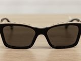 black and white sunglasses on a wooden table with a white background