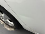a close up of a white car with a flat tire