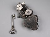 a small metal object with a key attached to it