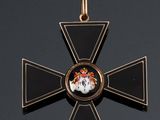 a close up of a cross with a picture of a man on it