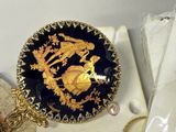 a blue and gold plate with a gold dragon on it