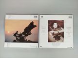 two cds with a picture of a woman and a man on top of them