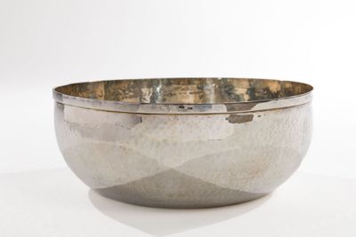 an image of a silver bowl sitting on top of a white table