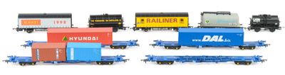 several toy trains are lined up in a row on a white surface