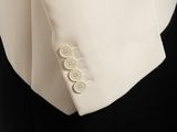 a close up of a white jacket with buttons on it