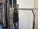 a rack with clothes hanging on it in a room