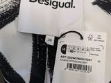 an image of a black and white shirt with a tag on it