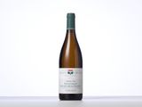 the bottle of white wine is sitting on the table