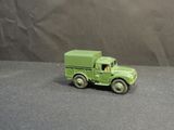 a green toy truck that is sitting on a table