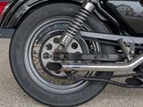 a black motorcycle parked in front of a building