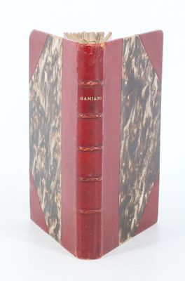 a red book that is open on a white surface