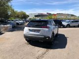 many cars parked in a parking lot near a building