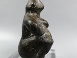 statue of a seated woman on a clear base