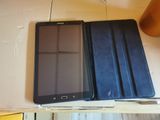 two tablet computers sitting on a table next to each other