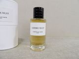 a bottle of perfume next to a container of perfume