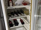 a refrigerator with many bottles of wine inside of it