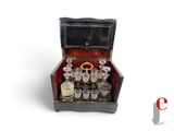 a small wooden box with a lot of glasses inside of it