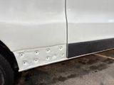 a white van with holes in the side of it