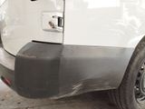a white van parked in a garage with a black door handle
