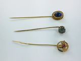 three gold - plated brooches with blue stones and gold - plated hair pins