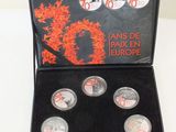 an image of a box of silver coins with a picture of a dragon on it