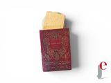 a red book with gold writing on it sitting on a white surface