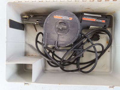 a box with a cord and a tool inside of it