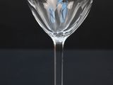 a wine glass sitting on a table with a black background