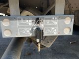 a close up of a car with a key attached to the back of it