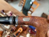 a person holding a pipe in their hand in a room