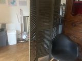 a chair that is sitting in front of a cabinet